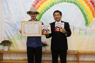 絵本を寄贈したパントビスコさんと原口新五市長